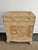 Carved wooden storage chest in a neutral blonde hue. Ornately sculpted with reliefs depicting Asian themed birds and...