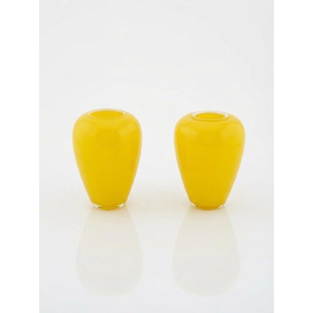 Add a vibrant pop of retro color to your space with this matching pair of mid-century modern art glass vases. Featuring a...