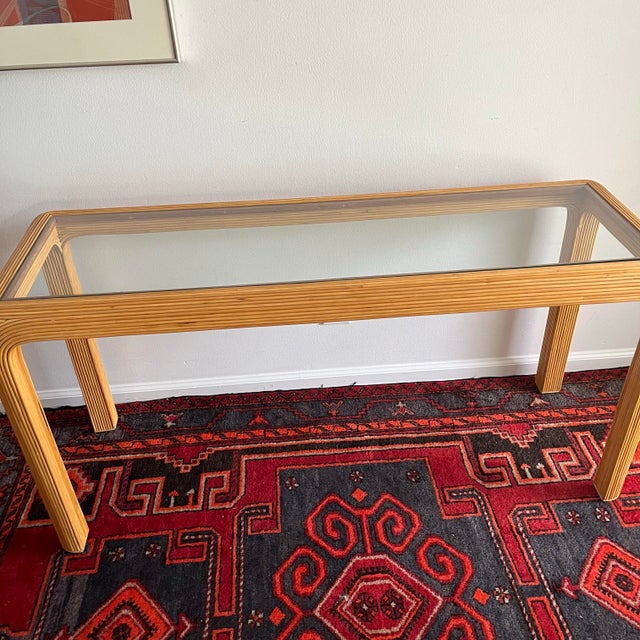 Vintage natural pencil reed waterfall console table with glass insert. Perfect for entryway or living room. Matching side...