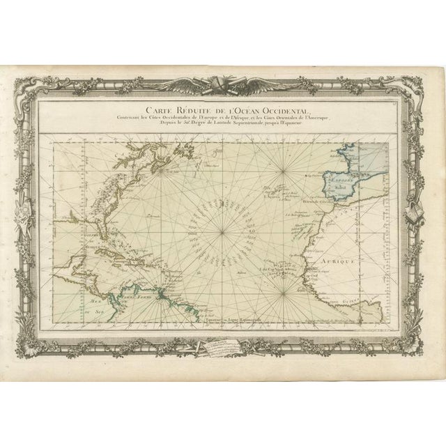 rare and highly decorative nautical chart titled “Carte Réduite de l’Océan Occidental,” engraved by the French...