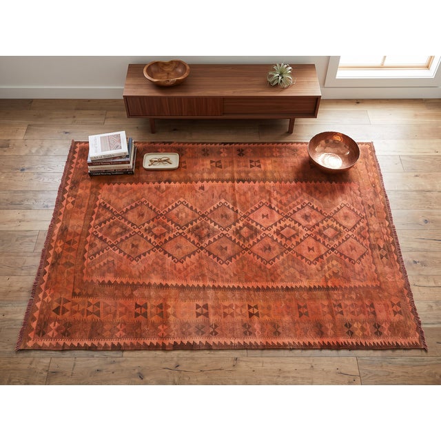 A vintage handwoven Maimana kilim from northern Afghanistan, overdyed in a warm terracotta. Maimana, in Faryab province,...