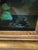 is a vintage 20th-century oil on canvas still life painting depicting flowers and fruit, often found in ornate gilt...