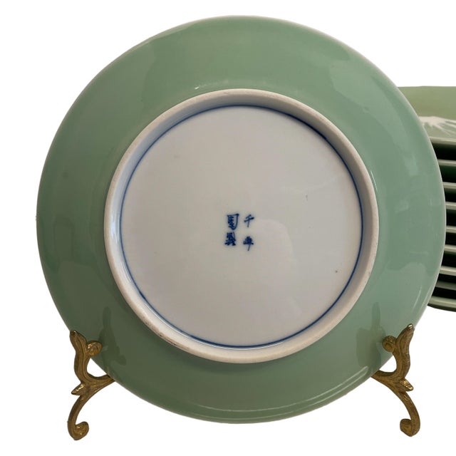 A fine set of ten antique Japanese celedon glazed Meiji period Mt. Fuji Plates, signed Nabeshima, circa 1900. Each...