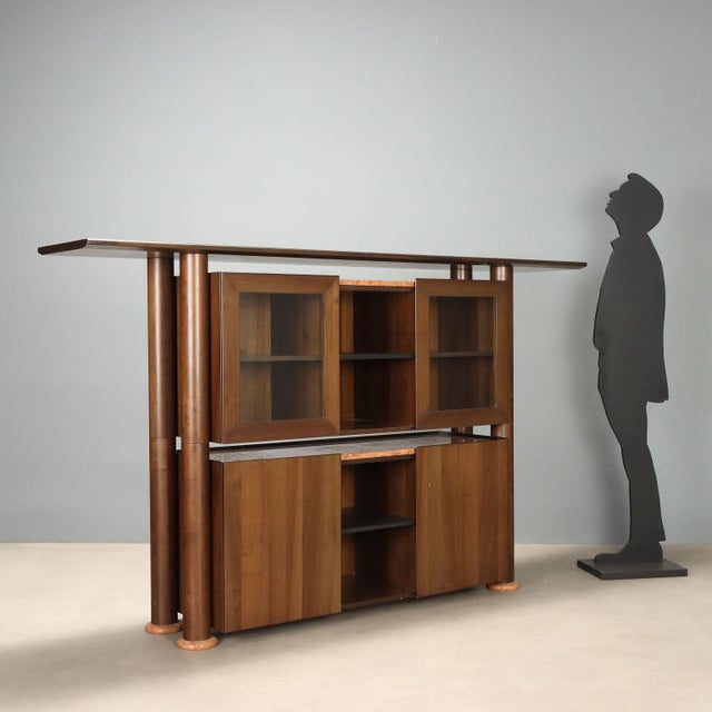 1980s sideboard crafted from stained Tanganyika walnut veneer, featuring a functional design and the typical elegance of...