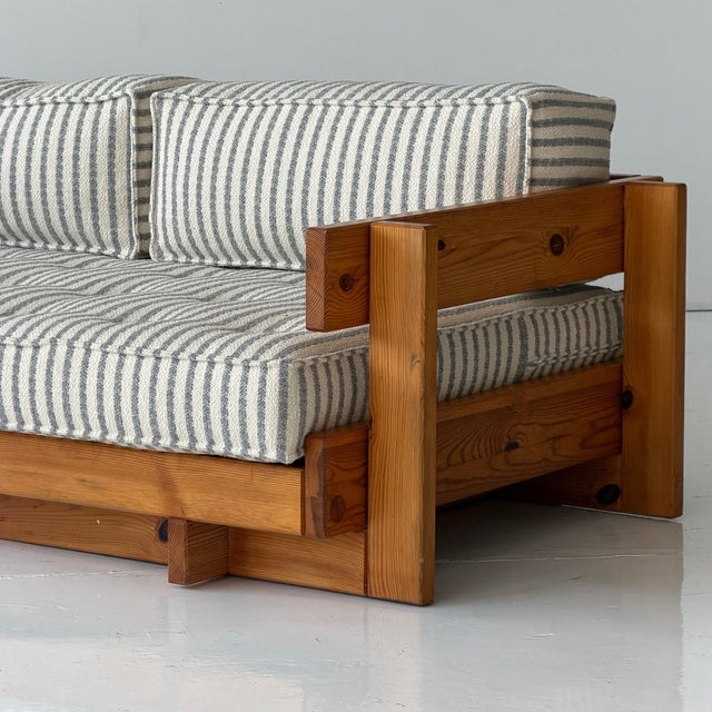c. 1970s. Constructed of full pine throughout. Reupholstered This piece is attributed to the mentioned designer/maker. It...