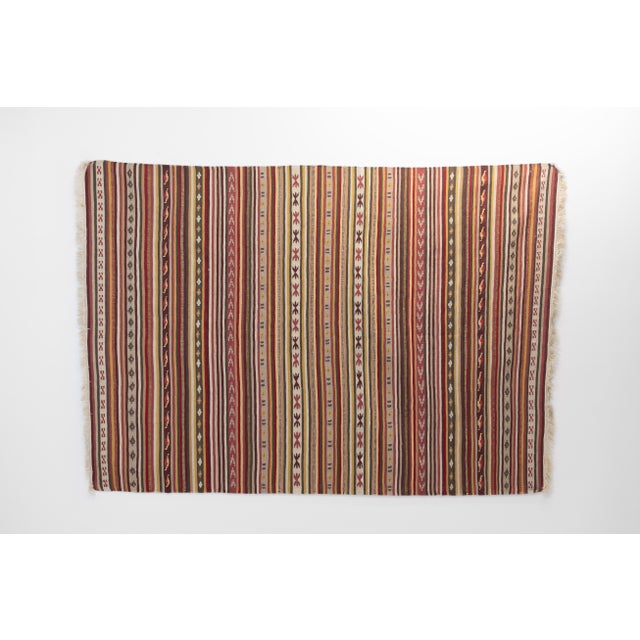 Vintage Turkish flatweave striped rug. Circa 1950s. All our rugs undergo a professional cleaning process. However, due to...