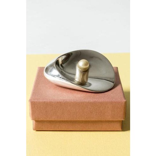 Beautiful silver brooch by Nanna Ditzel, model #328, in a smooth stylized form of a shell. Adorned with a cultured pearl....