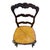 A striking set of six vintage French Country dining chairs featuring beautifully shaped ladder backs, carved decorative...