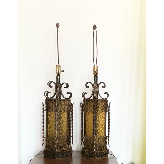 Matching pair of Mid Century, Spanish Revival Medieval Style wrought iron table lamps, on a hexagon base with textured...