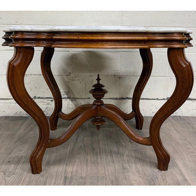 This is a gorgeous antique turtle top Victorian Eastlake parlor table, center table, or lamp table with white marble top...