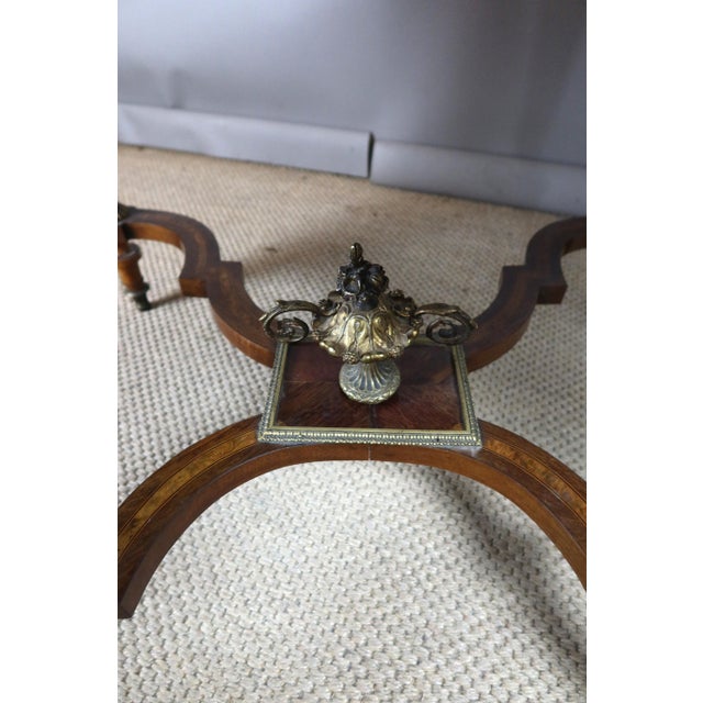 Napoleon III period marquetry centerpiece table. The top features a beautiful decoration of musical instruments and sheet...