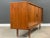 A mid century modern teak credenza with two sliding tambour doors made in Denmark by Dyrlund Furniture. Professionally...