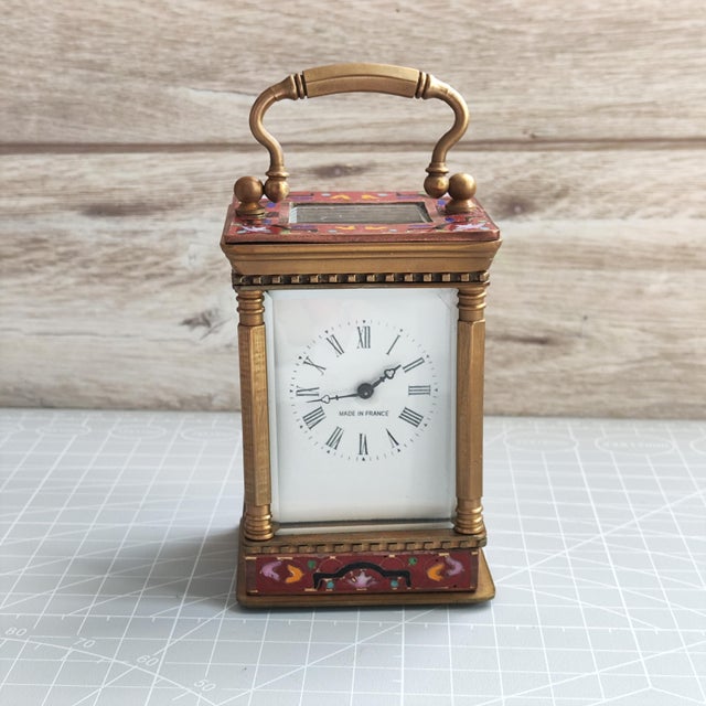 Antique French carriage clock (pendule de voyage) crafted in brass and adorned with exquisite champleve enamel work,...