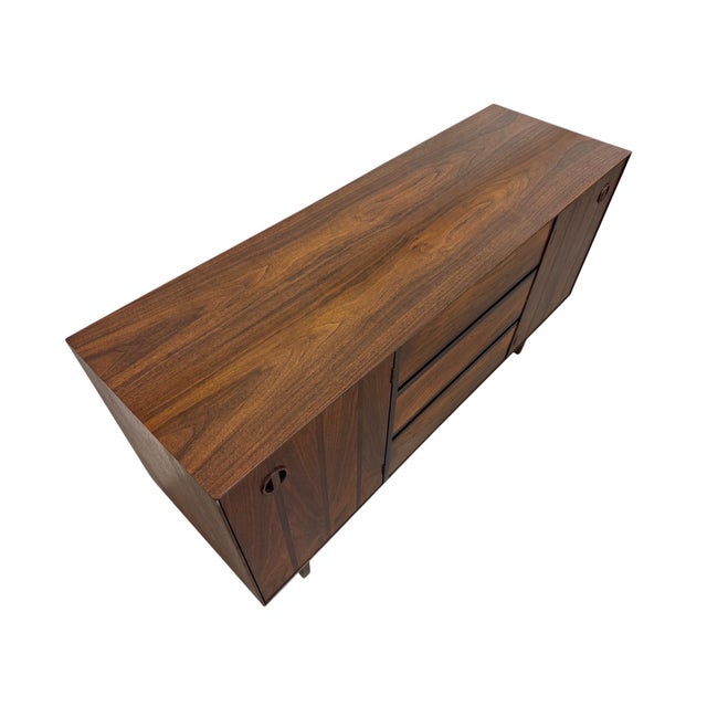Elevate your space with this stunning 1960s mid-century modern walnut sideboard by Stanley Furniture. Showcasing clean...