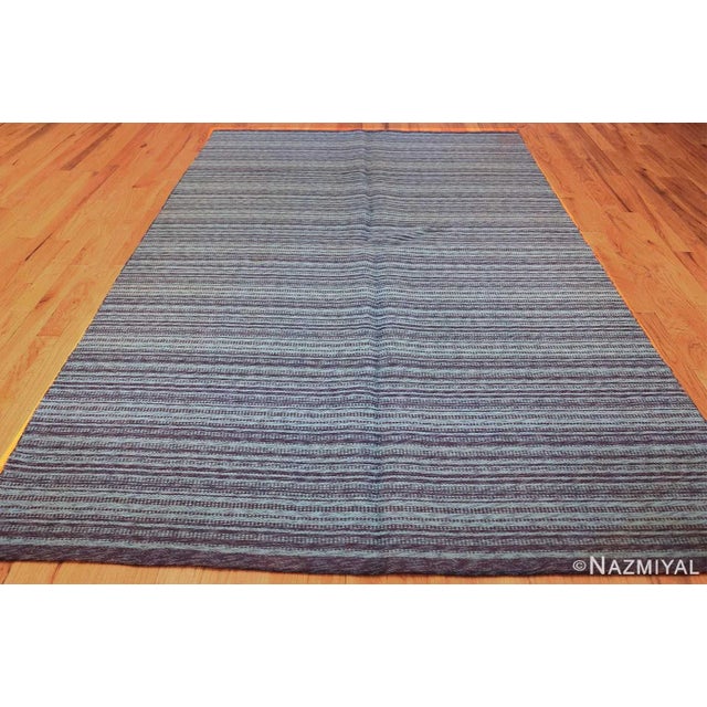 Alternating lines of dark midnight blue and bright azure are the hallmark of this incredible blue rug. The contrasting...