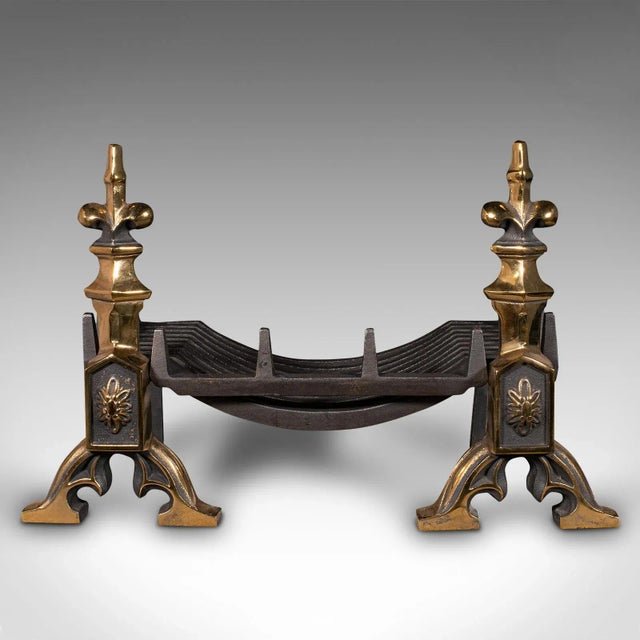 This is an antique Art Nouveau fireplace set. An English, cast iron fire basket with brass andirons, dating to the...
