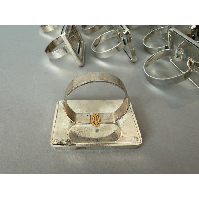This product is a set of 10 silver tone metal napkin rings, picture frame place card holders. The elegant design of the...