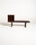 Rosewood bench with a long, low top, frame legs, and a matching mobile record rack divided into four compartments. Made by...