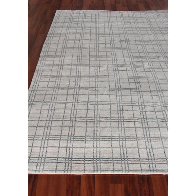 The Fairbanks rug catches your eye with its sharp and fresh plaid pattern motif, soft sheen and soothing colors....
