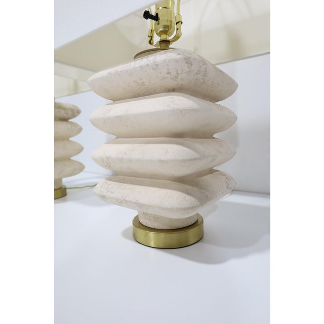 Beautiful travertine lamps in a stacked silhouette. lamps are newly wired with brass base and brass fittings. We paired...
