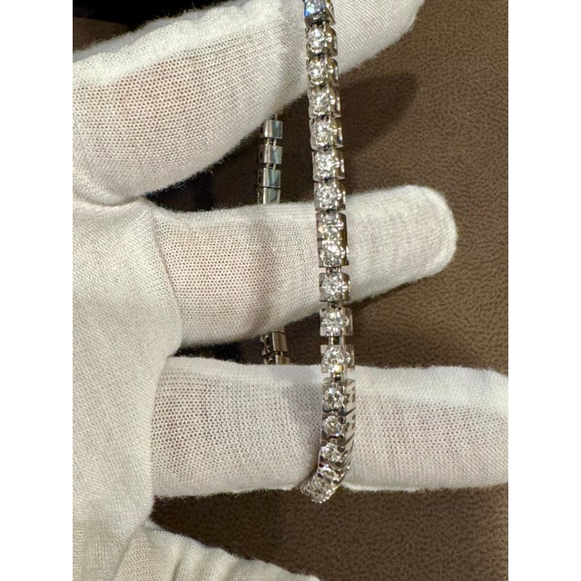 Iconic and stylish, this flexible diamond bangle bracelet is designed to make a statement. Crafted from 18K White, Yellow,...