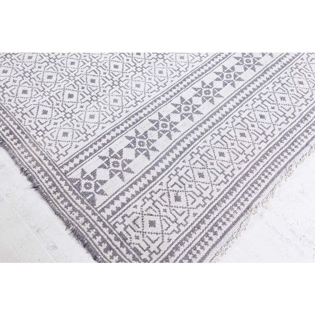 A Midcentury North Indian Agra cotton size adjusted runner features a primitive geometric pattern with diamond shapes in...