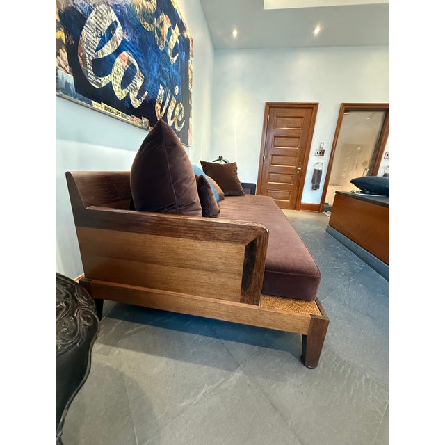 Christian Liaigre “Opium” Daybed, circa 2000. Dark stained wood frame with woven cane detail and upholstered cushions. A...