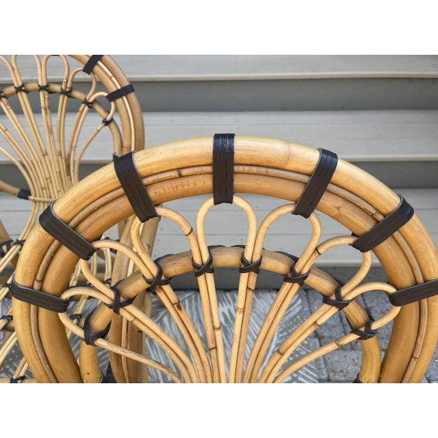 Natural rattan and warm brown leather bindings are used to craft these stunning arm chairs. They are in excellent...