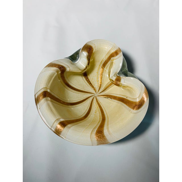 Offered here is a beautiful and heavy cased glass Murano bowl featuring gold and white stripes, circa 1950s. Documented to...