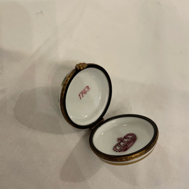 A Fine French Limoges, porcelain hand painted box with metal accents and Floral clasp. The top with green foliage and...