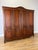 An elegant Vintage French Louis wardrobe with a substantial four-door design, decorative carved detailing, shaped upper...