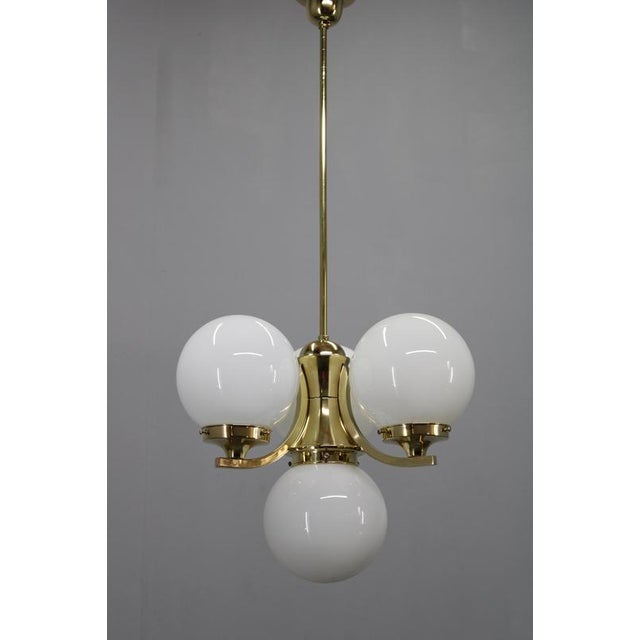This elegant art deco chandelier was produced in czechoslovakia during the 1930s and showcases the refined geometry and...
