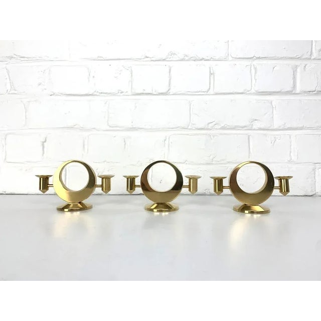 A set of three Mid-Century Candelabras for 2 candles each in solid brass. Created and made by Arthur Petterson, he signed...