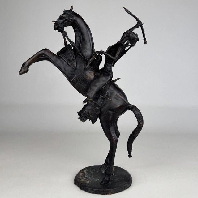 A striking 19th-century bronze equestrian sculpture depicting an African horseman mounted upon a dramatically rearing...