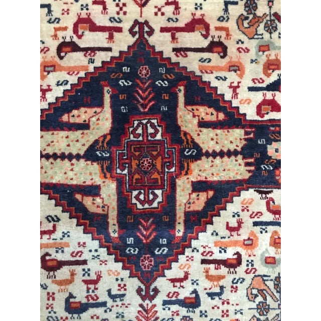 Nice vintage Ghashghai rug with tribal design with animals, beautiful colors with blue, red and orange. Finely hand...