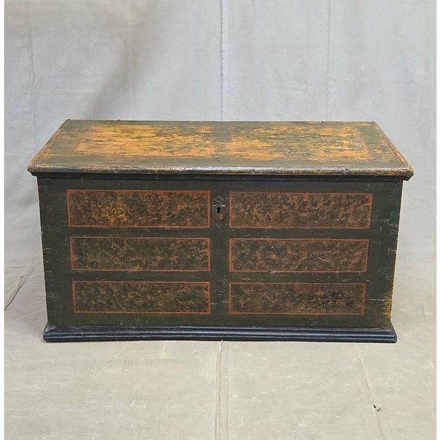 A beautiful antique European rustic hand-crafted pine blanket chest with original paint on the front and sides... a dark...