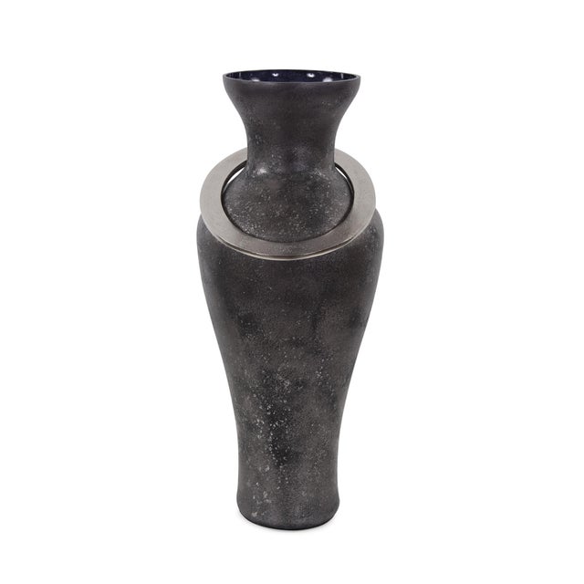 The black ore vases derive their name from a recent trip to a stone quarry. After watching massive sections of dark black...