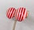 1970s gold-tone round domed clear resin clip earrings with red and white stripes. Marked crown "TRIFARI©" on the clips....