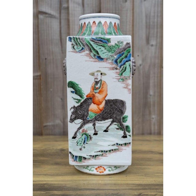 A striking Chinese porcelain Cong-form vase, distinguished by its architectural square profile and richly coloured famille...
