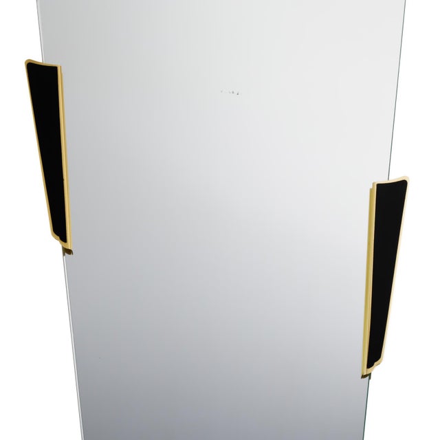 This asymmetrically shaped wall mirror was manufactured in the 1950s through the 1960s. Its organic form, frameless mirror...