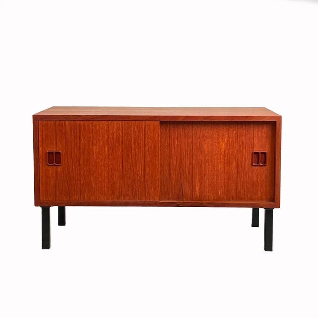 Adorable teak storage cabinet, providing storage solutions for the entry foyer, bedroom or as a media cabinet. Crafted in...