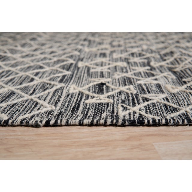 Penelope Kilim Brown Handmade Wool Rug, Country of Origin: India. This exceptional flat-woven piece showcases the enduring...