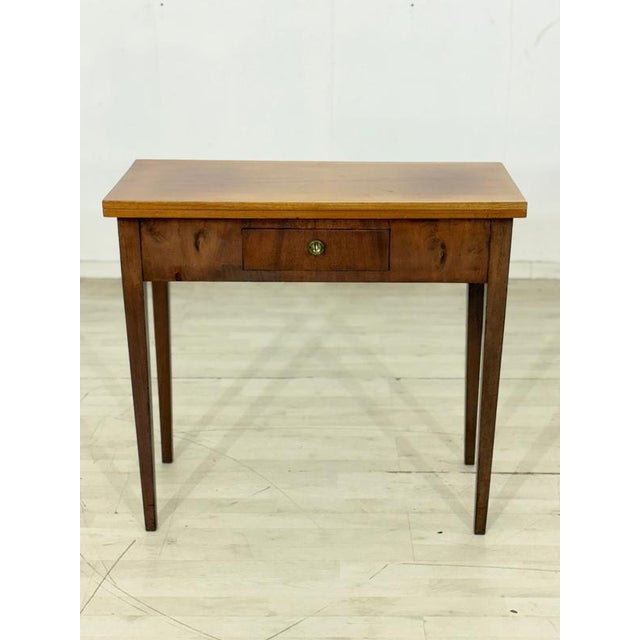 Elegant antique console table made of fine mahogany, crafted around 1920. This piece of furniture impresses with its...