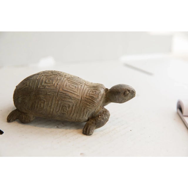 :: Vintage handmade African tortoise sculpture. Circa late mid 20th century, each figure in this collection represents a...