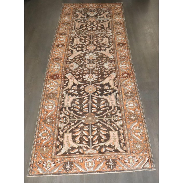 An early 20th-century brown Persian Bakhtiari corridor size rug