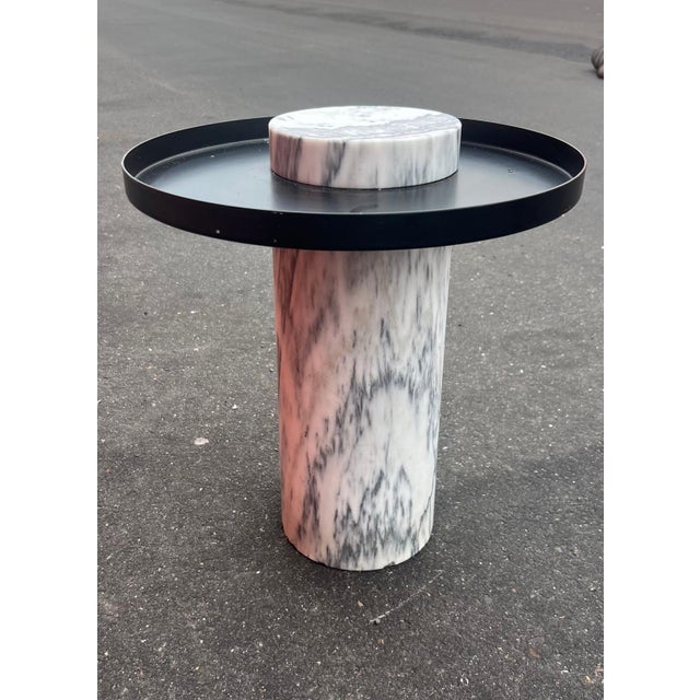 This very unusual and artistic accent table has a deco style to it. It is black metal and solid Carrera marble. Could be...