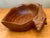 This vintage carved wood bowl is a striking example of mid-century decorative craftsmanship, thoughtfully shaped in the...