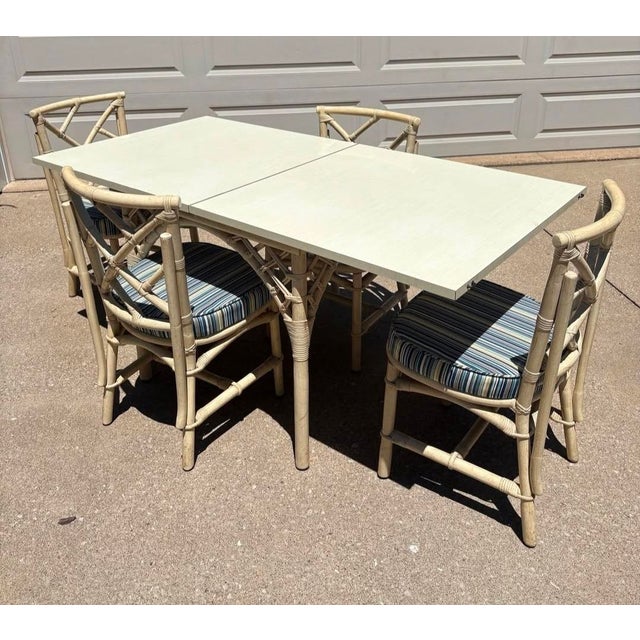 Vintage Painted bamboo table and chair dining set with blue striped seat cushions. Includes 4 chairs and a clever...