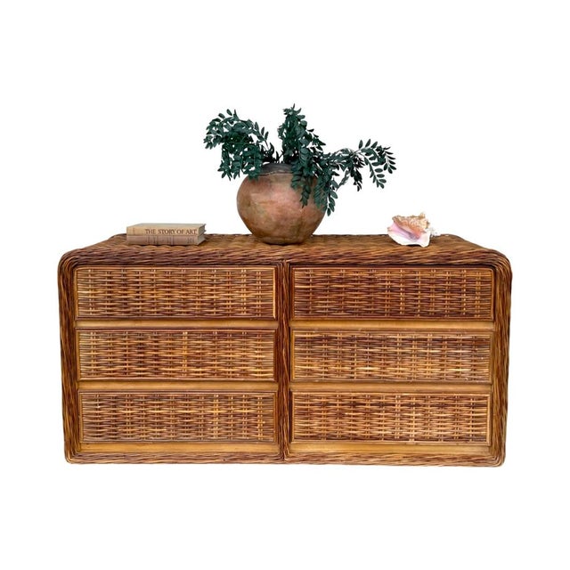 Stunning coastal wicker dresser with waterfall edge and braided wicker trim. The piece is in excellent overall condition...