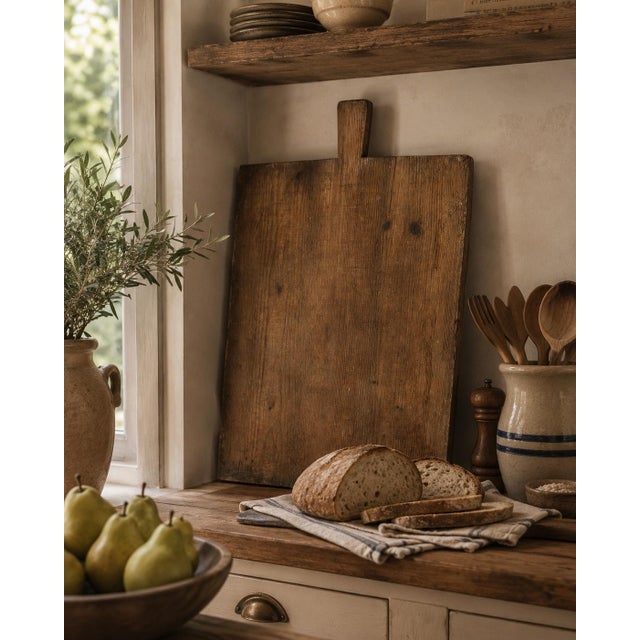 A substantial late 19th century French wooden bread board with a broad rectangular form, integral handle, and beautifully...